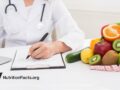 a doctor next to pile of produce