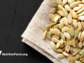 roasted pumpkin seeds on cloth over black surface