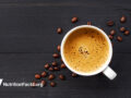 hot coffee and beans over a slate surface