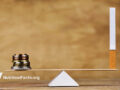 Balance of money and cigarette on a scale