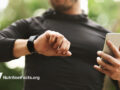 Man looking at smart watch outside