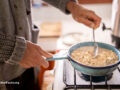 Person cooking oats on stovetop