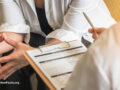 Two people evaluating a medical file
