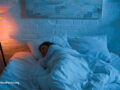Person wrapped up in bed sleeping