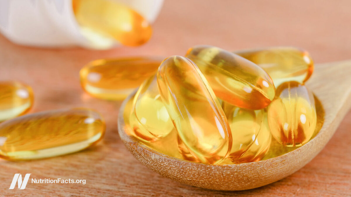 Liquid gel capsules in a wooden spoon