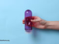 An intimate lubricant in a female hand on a blue background