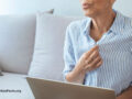 woman touching shirt and having hot flash